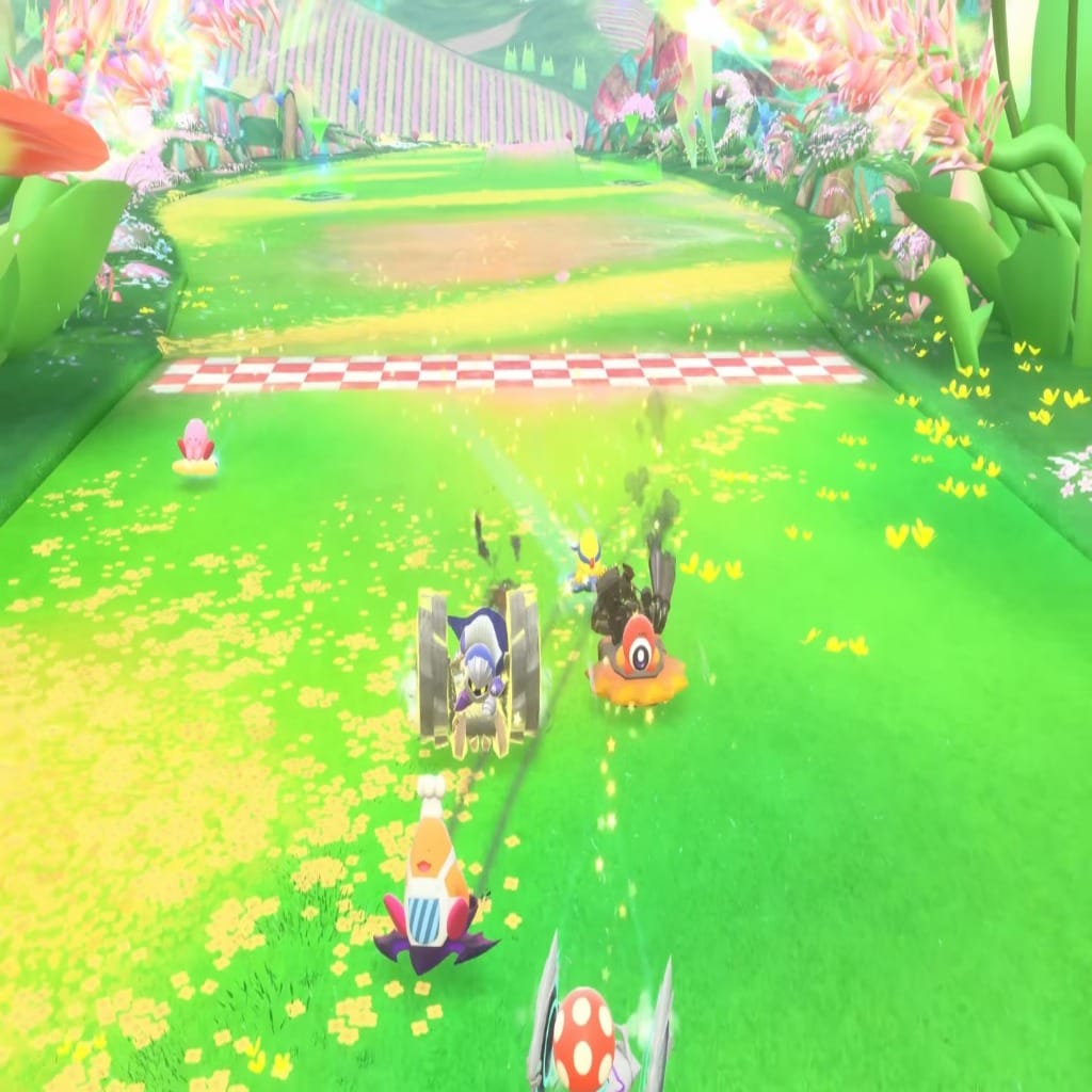Kirby Air Riders race scene with multiple characters approaching the finish line on a bright, colorful grassy track.